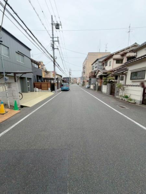 ���{�����s�썃�r��2���ڂ̐V�z��ˌ��Ă̑O�ʓ��H�܂ތ��n�ʐ^